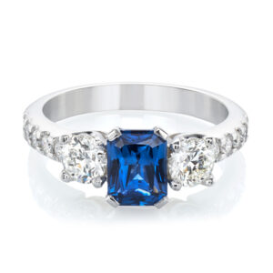 Radiant cut three stone blue sapphire and diamond ring