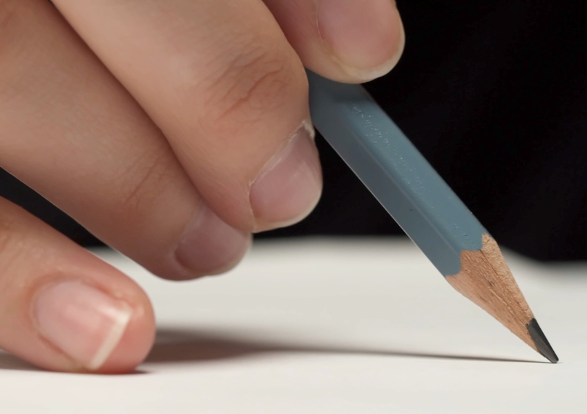 hand holding a pencil and sketching