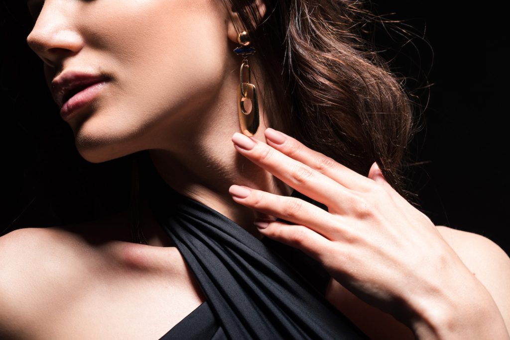 A glamorous woman at a formal event in Adelaide, showcasing a stunning custom earrings