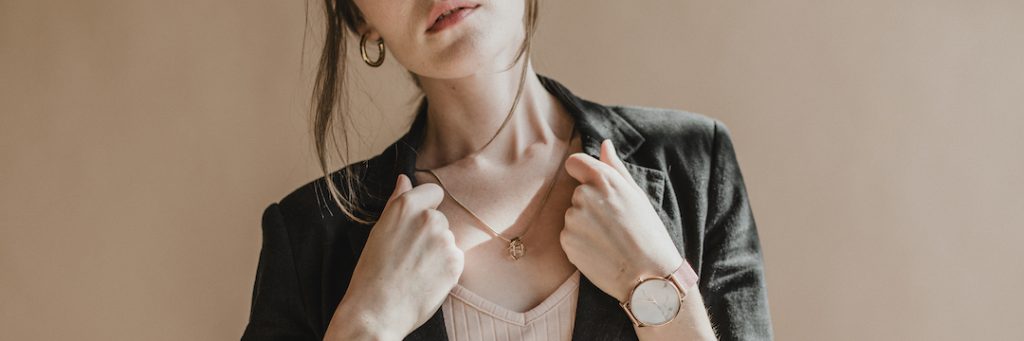 Woman wearing a black blazer with jewellery