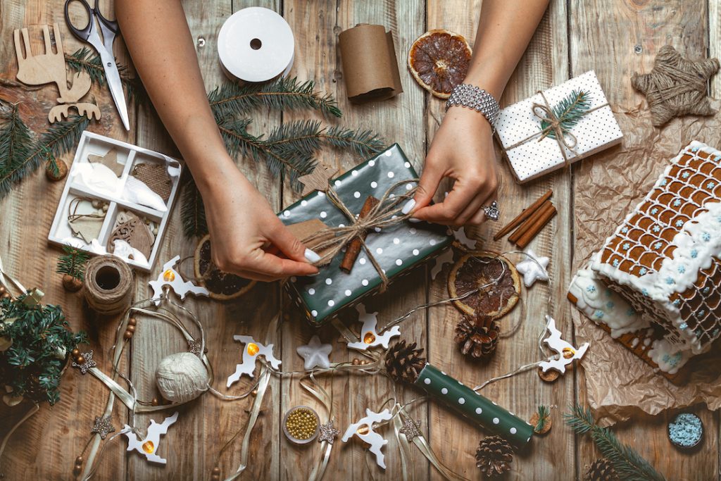 Young woman wrapping and decorates christmas present