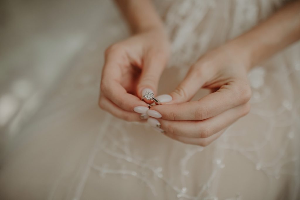 bride holding her engagement ring