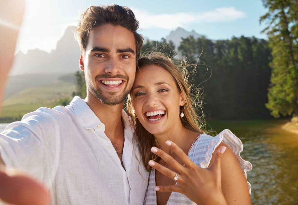 Shot of a young couple taking a selfie after getting engaged