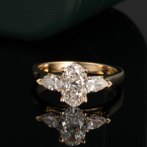 oval diamond and pear cut diamond three stone engagement ring
