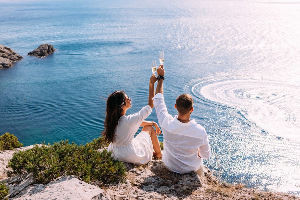 A couple in love celebrates their engagement on the seashore in australia