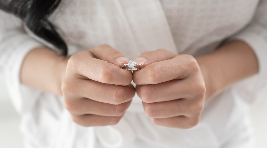 Bride in White bathrope with elegant diamond ring for wedding day