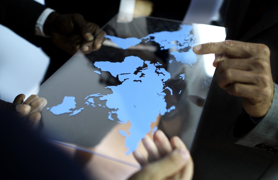 team looking at world map
