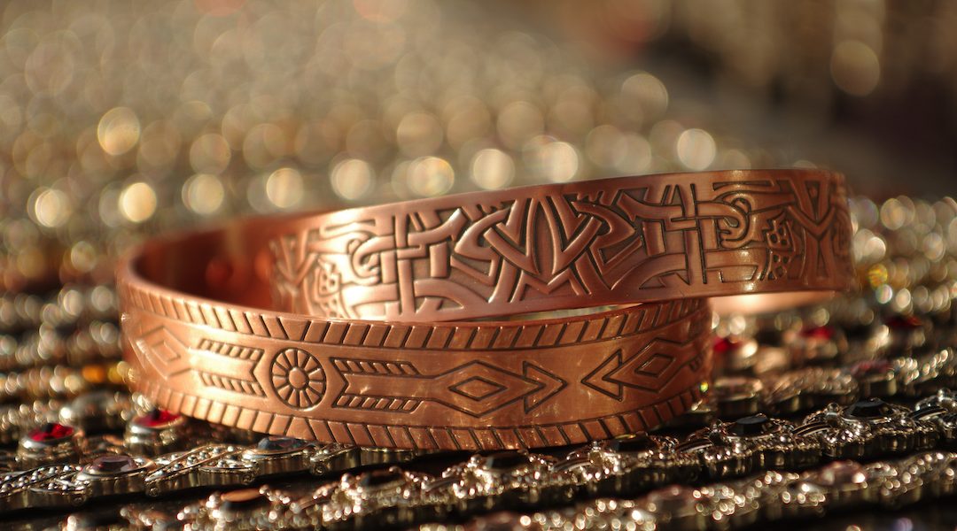 Closeup shot of copper bracelets with patterns engraved