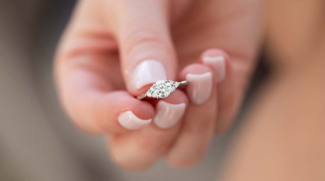 A closeup shot of female hand holding a luxury diamond ring
