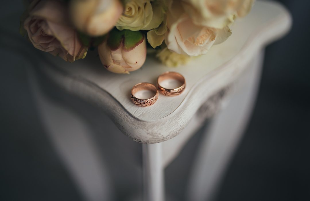 Wedding rings with flowers on the table